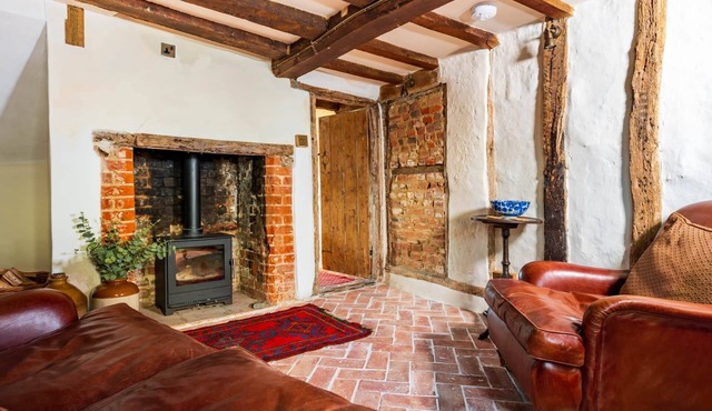 Charming medieval cottage courtyard garden and wood burner in serene Kersey